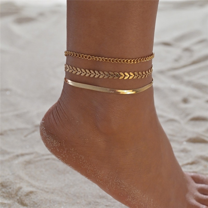 Simple chain anklet set for women styled on ankle with sandals Simple chain anklet set for women styled on ankle with sandals