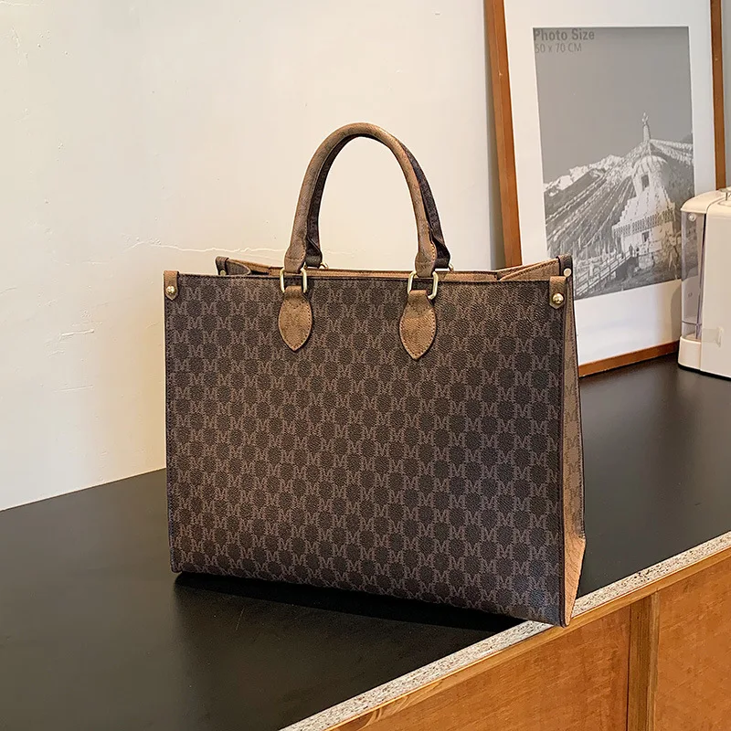 Front view of a vintage monogram retro shoulder bag in faux leather