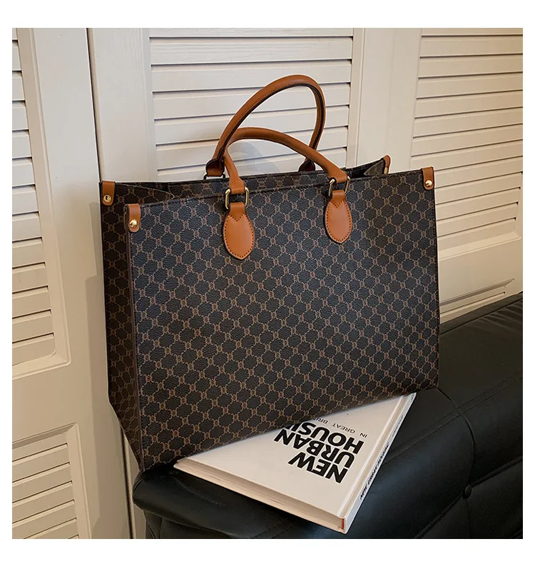 Front view of a vintage monogram retro shoulder bag in faux leather