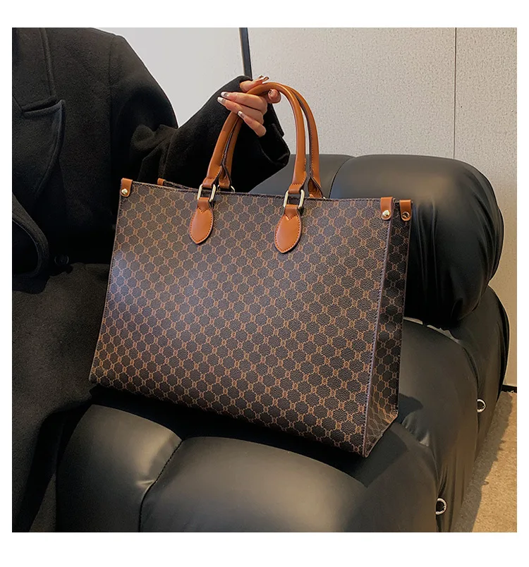 Front view of a vintage monogram retro shoulder bag in faux leather