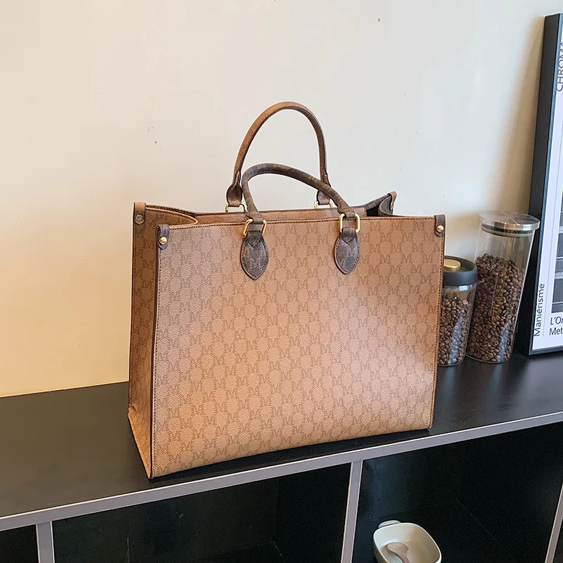 Front view of a vintage monogram retro shoulder bag in faux leather