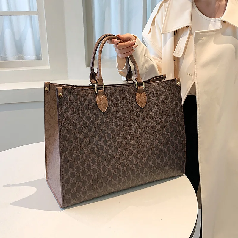 Front view of a vintage monogram retro shoulder bag in faux leather
