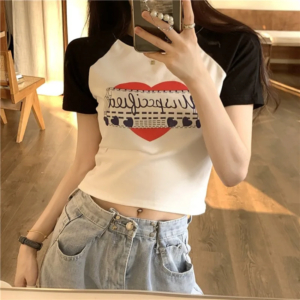 Model wearing a vintage graphic print y2k crop top styled with streetwear jeans