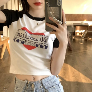 Model wearing a vintage graphic print y2k crop top styled with streetwear jeans