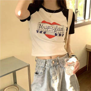 Model wearing a vintage graphic print y2k crop top styled with streetwear jeans