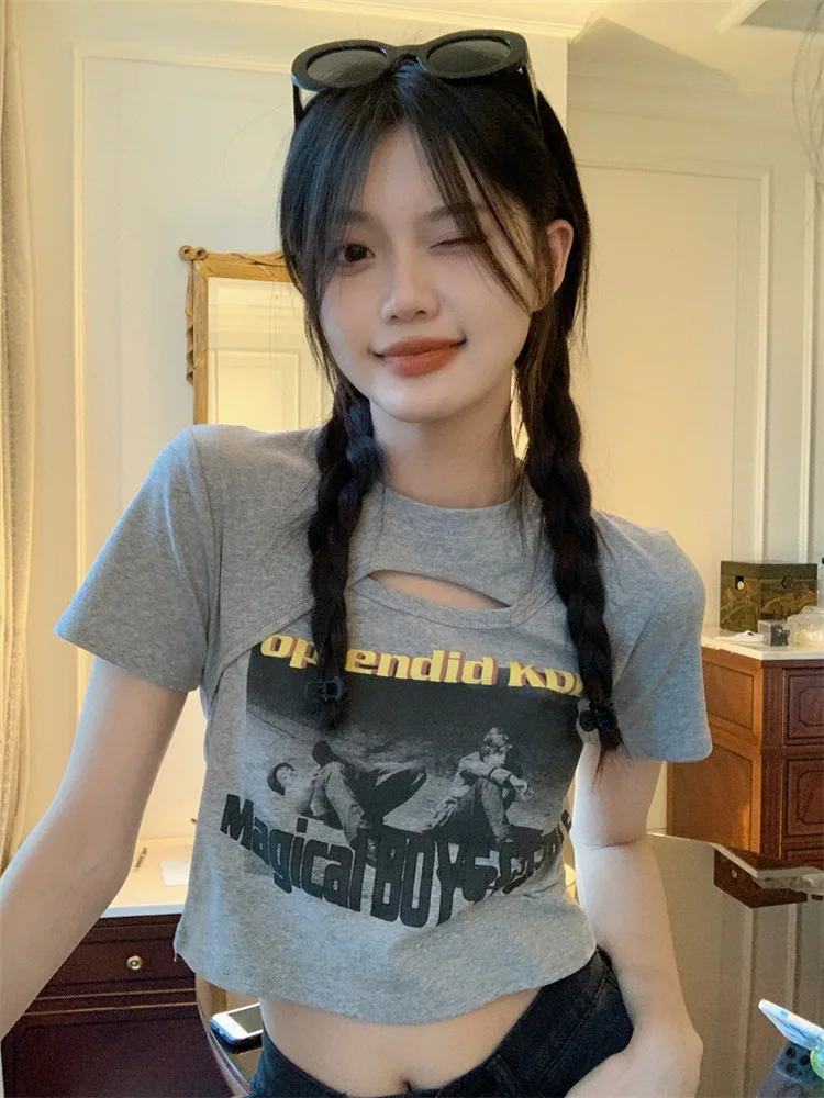 Woman wearing a Y2K style short sleeve hollow out crop top in a street style setting