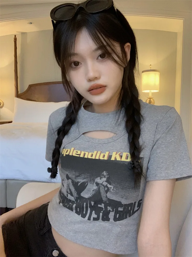 Woman wearing a Y2K style short sleeve hollow out crop top in a street style setting