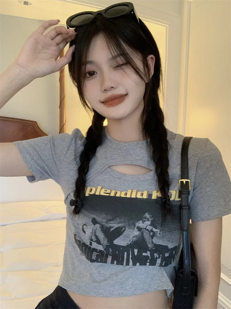 Woman wearing a Y2K style short sleeve hollow out crop top in a street style setting