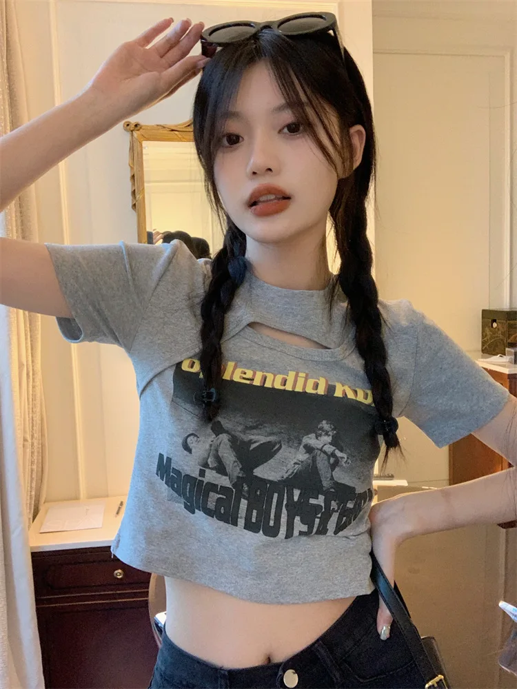 Woman wearing a Y2K style short sleeve hollow out crop top in a street style setting
