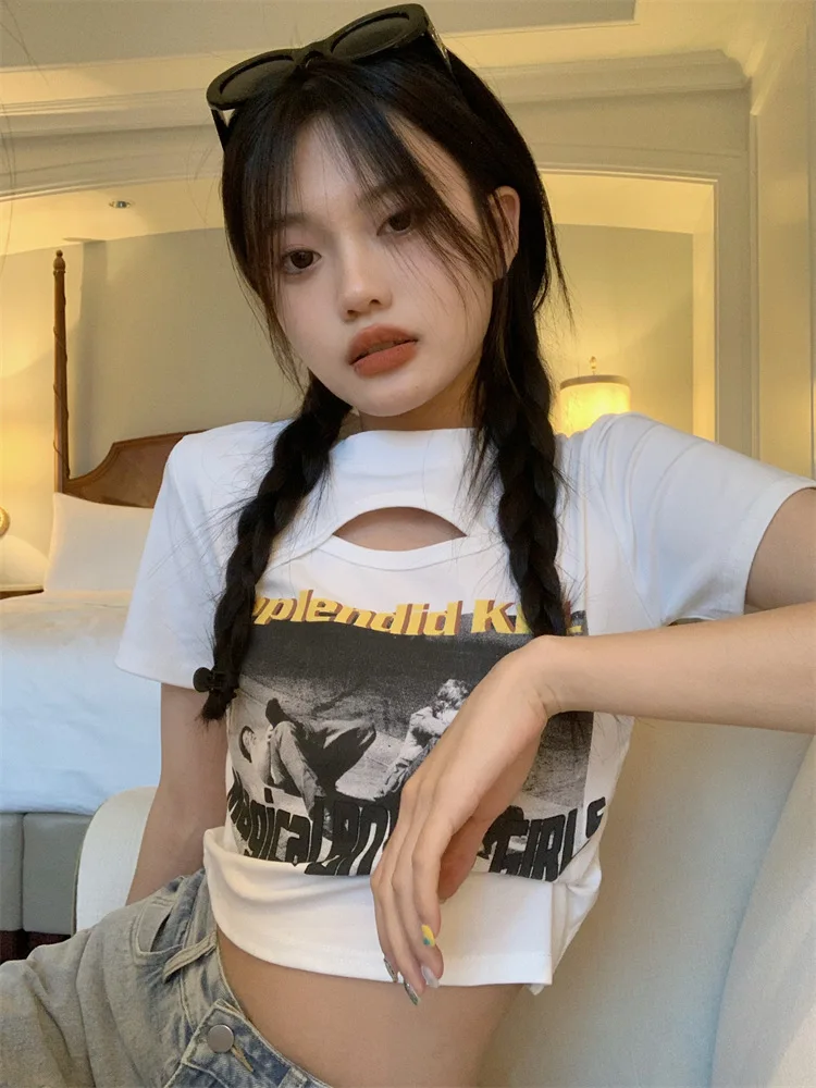 Woman wearing a Y2K style short sleeve hollow out crop top in a street style setting