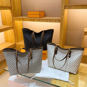 Model wearing a sleek minimalist pu leather tote bag carried over the shoulder in a city setting