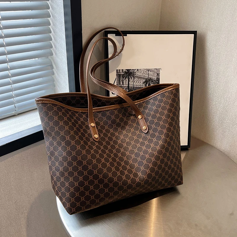 A model wearing a sleek minimalist pu leather tote bag carried over the shoulder in a city setting