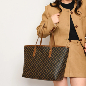 Model wearing a sleek minimalist pu leather tote bag carried over the shoulder in a city setting