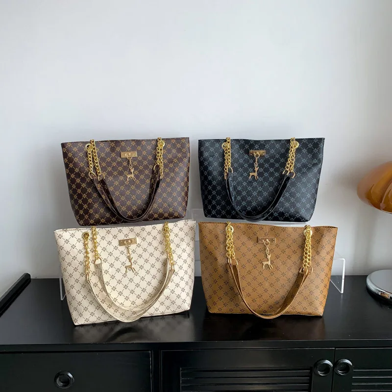 Monogram print soft leather tote bag with hanging charm accessory