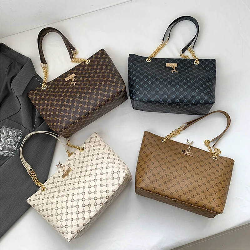 Monogram print soft leather tote bag with hanging charm accessory