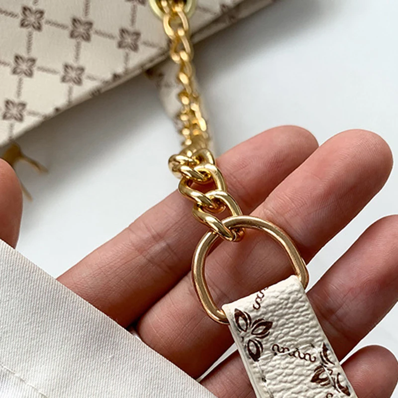 Monogram print soft leather tote bag with hanging charm accessory