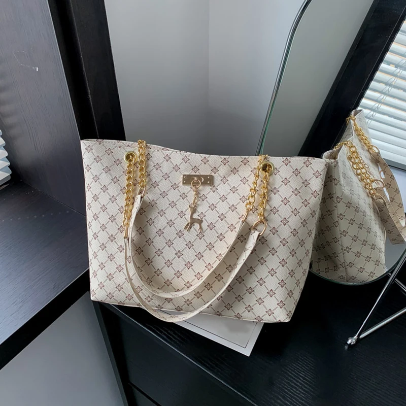 Monogram print soft leather tote bag with hanging charm accessory